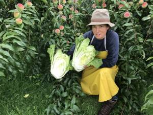 Farmer Madalyn Warren with a Napa cabbage, the classic kimchi ingredient.