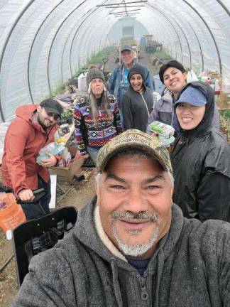 Michaeline Mann (in colorful fleece) and Vincent Mann (front), Turtle Clan Chief of the Ramapough Lenape Nation, at their farm in Newton, NJ. They have been getting a lot of calls, because they are on the short list of historically underserved farms.