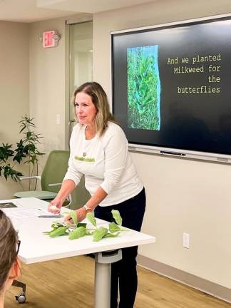 Volunteer Kelly Spranger gives a PowerPoint presentation at the Tuxedo Park library in spring 2024