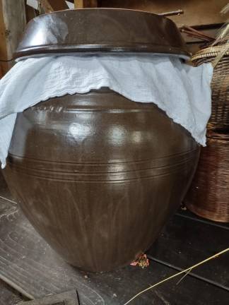 Onggi (Korean earthenware crock) full of fermenting soybeans for bean pastes and soy sauce