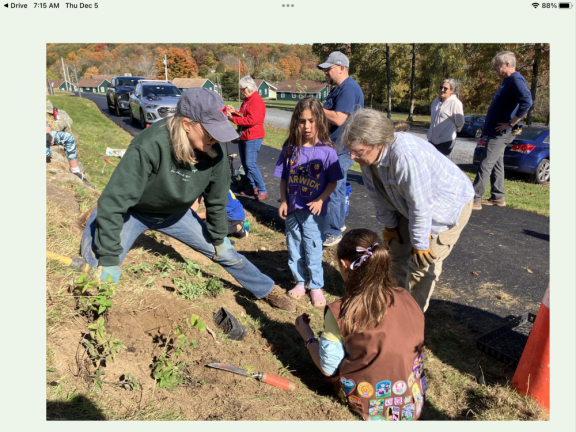 Sally Greco (left) and Dr. Anne Wibiralske work with kids installing a pollinator garden at Mountain Lake Park in Warwick, NY.