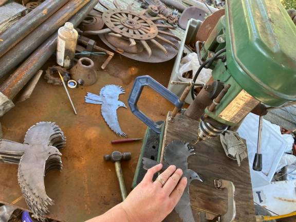 Sweetman drills hanging holes in her bluebirds.