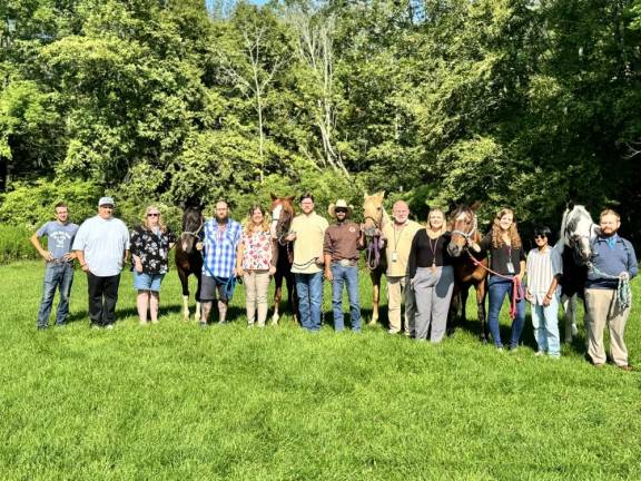 Staff of the Malibu Wellness Ranch alongside the horses with which clients are paired up.