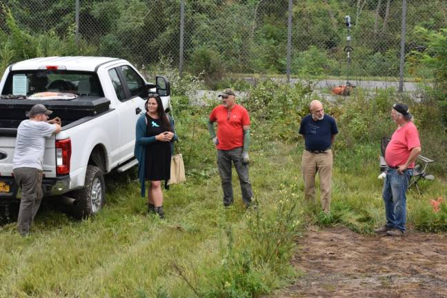 A team powwow at the site in August. From left: Connor Smith, Amy Sweetman, Greg Galluccio, Geoff Howard and Jeff Zahn