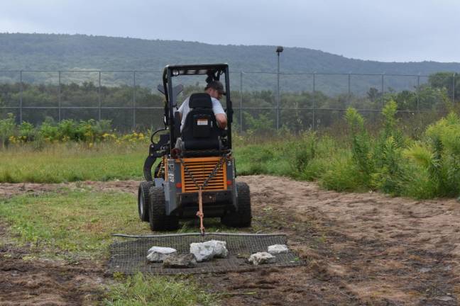 Arborist Connor Smith attempting to harrow the future pollinator garden in August. It turned out to be too wet, so the team did the job a couple weeks later.