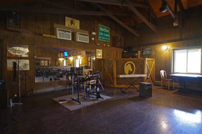 The former stage area where live performances once took place is neatly transformed into an area for creative music-based therapy and lessons.