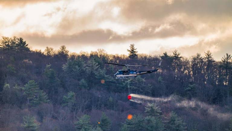 A helicopter fighting the 5,200-acre Jennings Creek fire in Greenwood Lake, NY on Nov. 12, in which an 18-year-old forest ranger died.